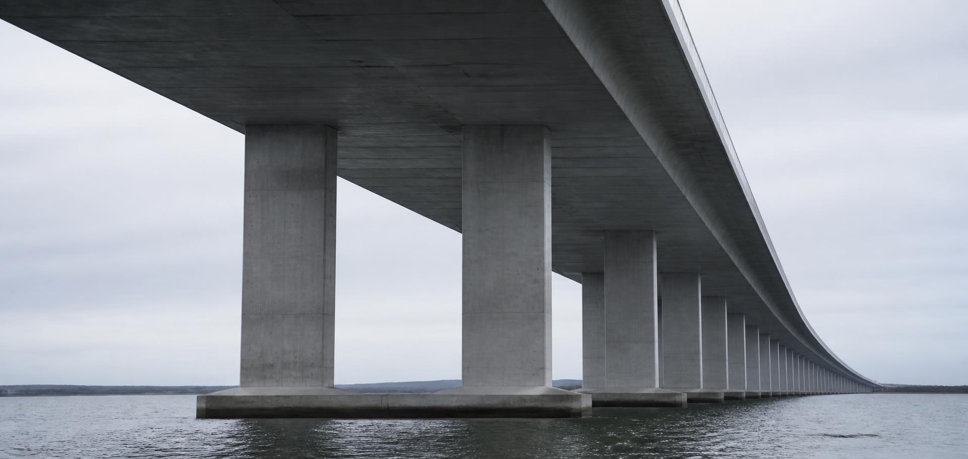 Long-span bridge crossing wide water under an open sky